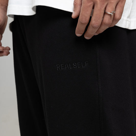 REALSELF EMBROIDERY LOGO WIDE LEG BLACK JOGGING PANTS
